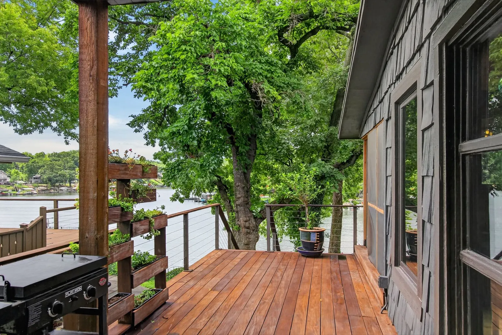Back deck with grill and planter boxes overlooking the lake at 31 H Street, Lake Lotawana