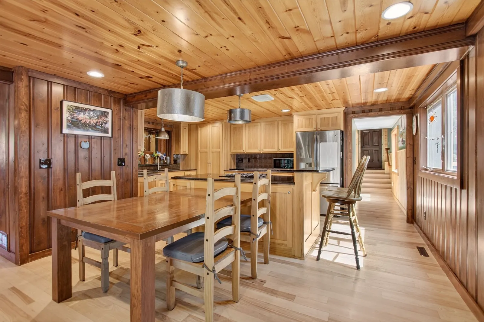 Dining room with farmhouse table adjacent to the kitchen at 31 H Street, Lake Lotawana