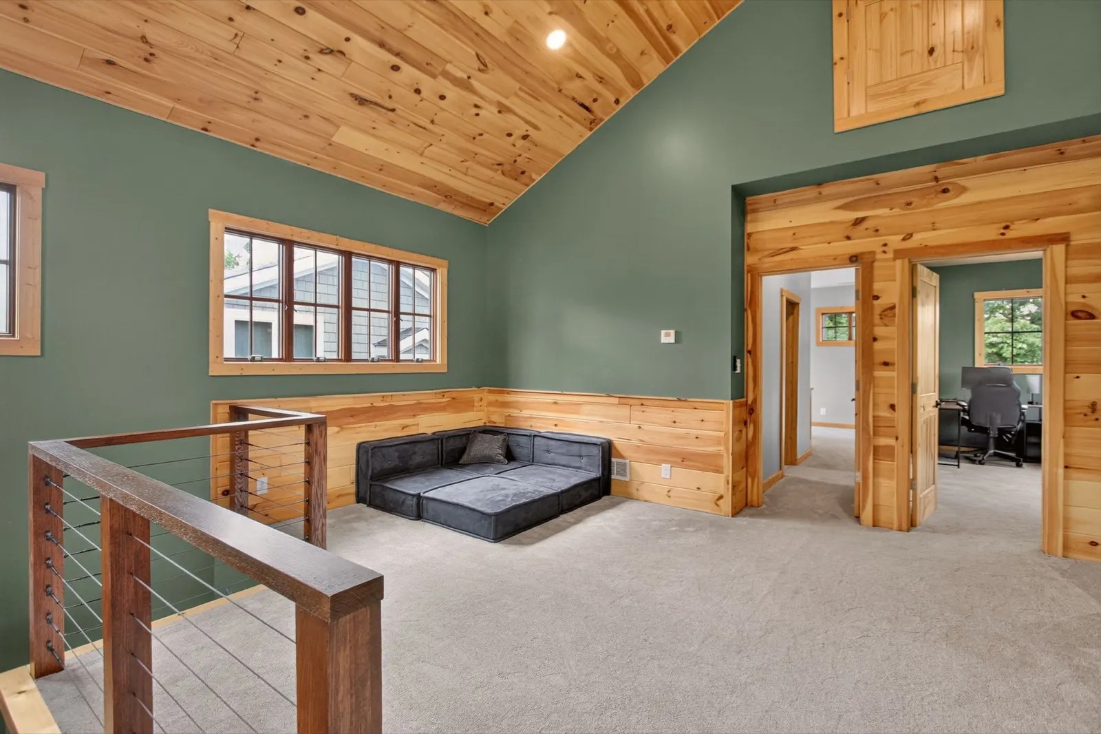 Upstairs loft sitting area with green accent wall and home office beyond at 31 H Street, Lake Lotawana