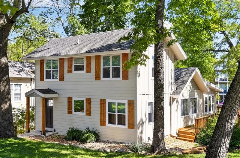 Front exterior of 7 & 95 H Street, a renovated two-story home with new siding and rust-colored shutters, Lake Lotawana