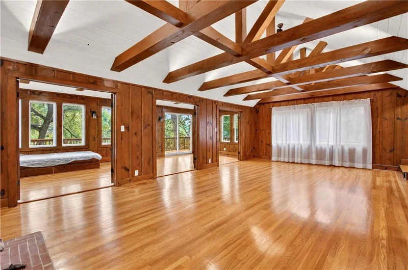 Living room under a vaulted ceiling with exposed wood beams