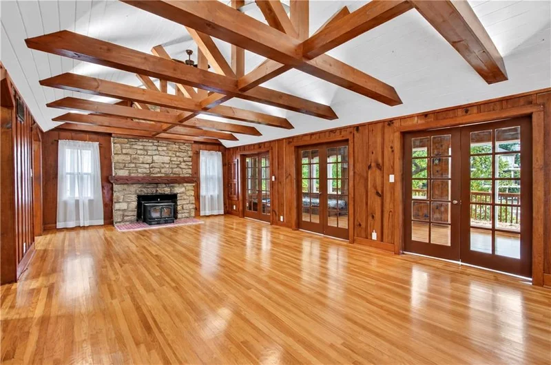 Great room with the stone fireplace and French doors to the deck