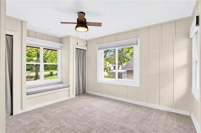 Carpeted bedroom with a window seat
